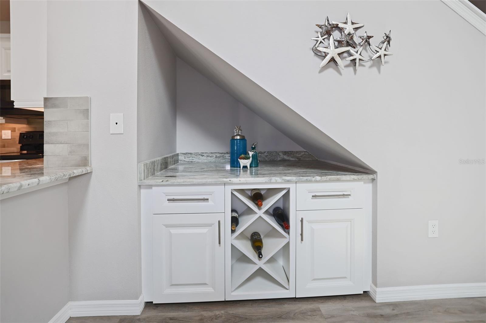 Wine bar and cabinetry under the stairs