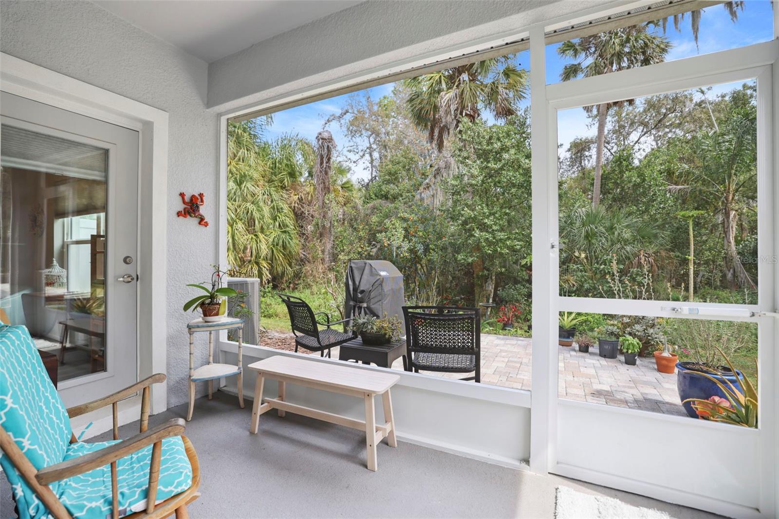 Back screened lanai looks to nature preserve