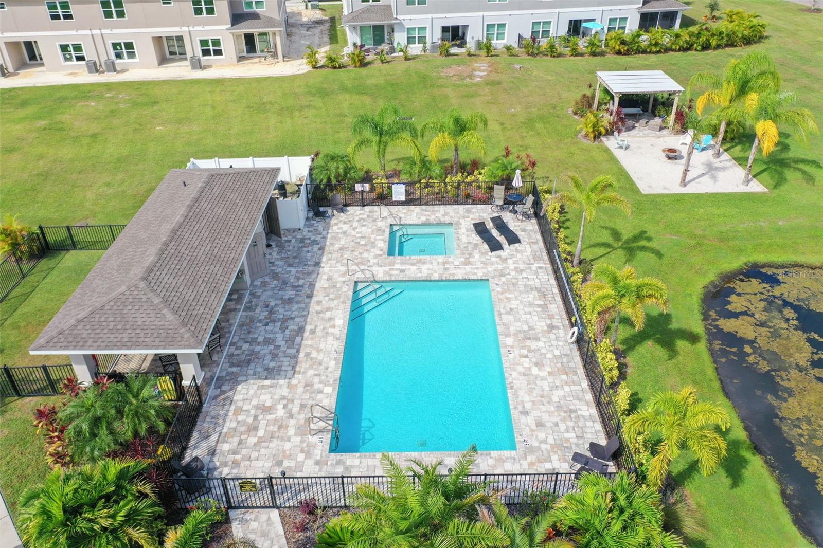 Pool area with bathrooms and covered picnic table