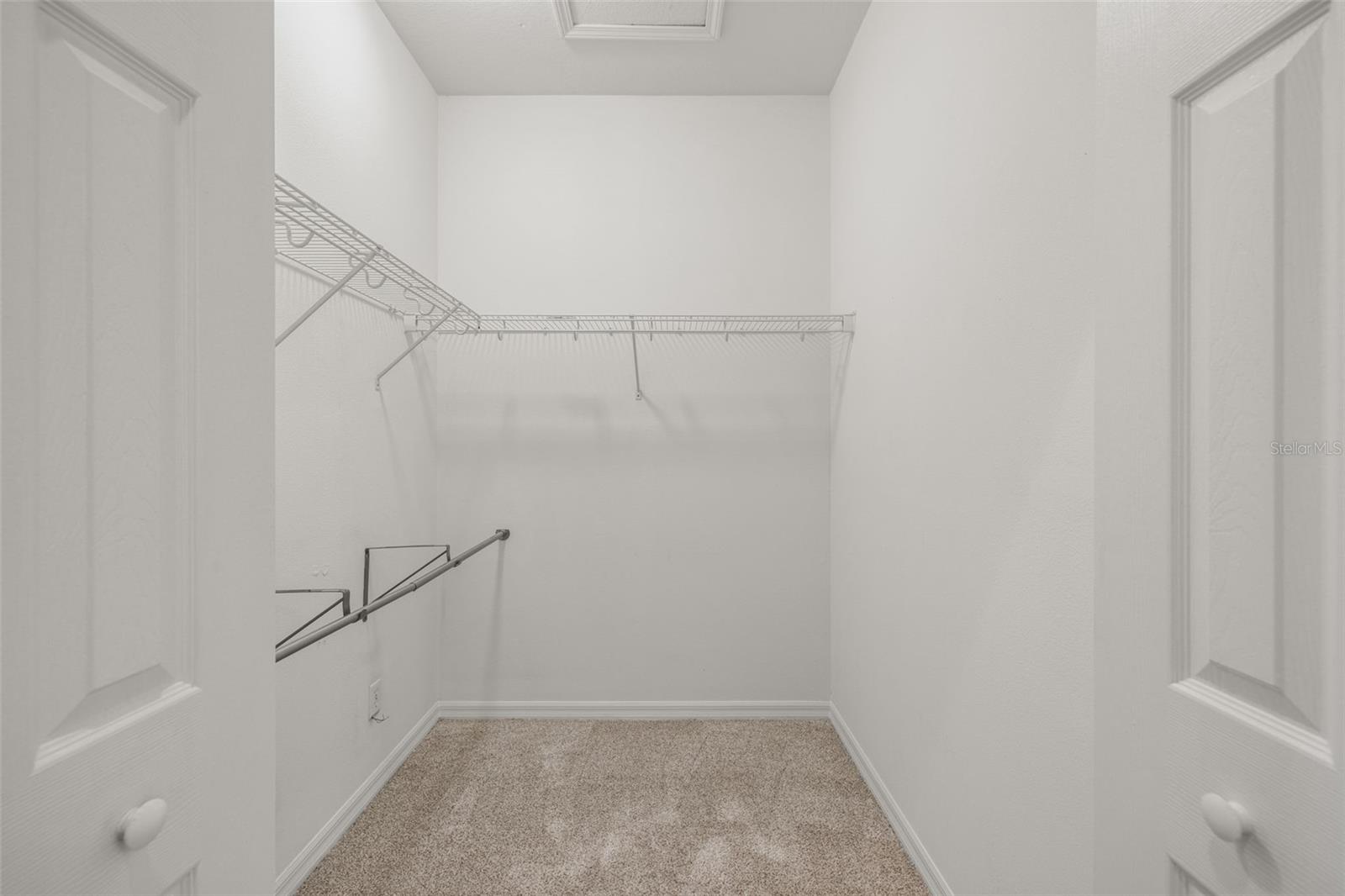 Primary bedroom walk in closet