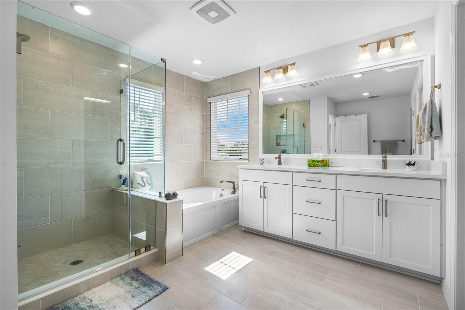 Two sinks and plenty of storage in the spacious primary bath vanity.