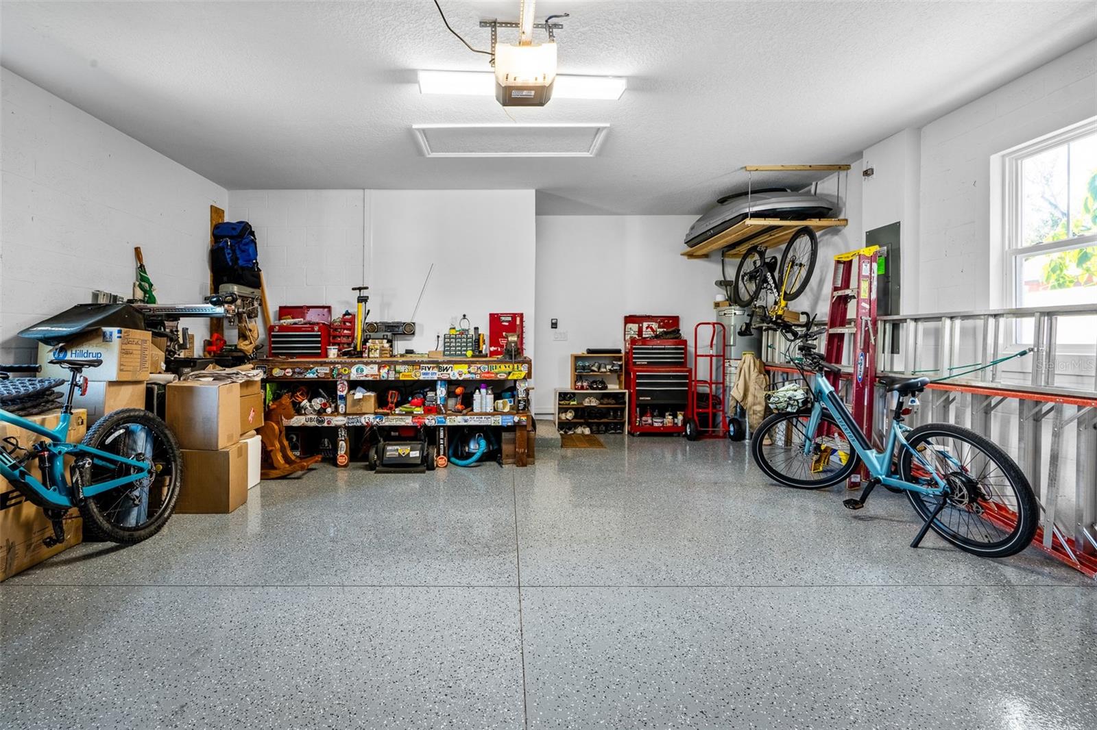A spacious garage with beautifully epoxied floors faces the alley at the rear of the home.