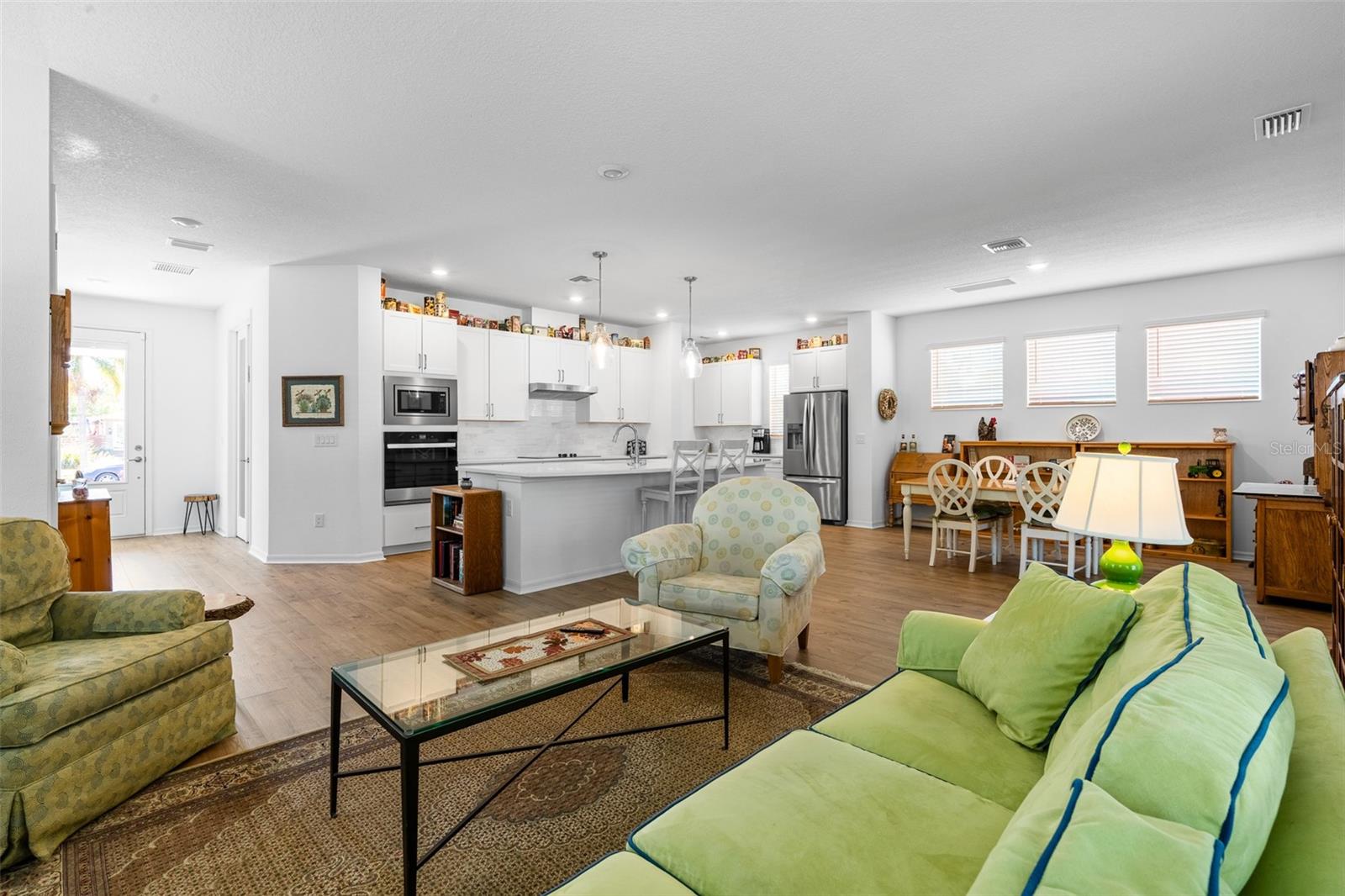 Living room looking into the kitchen and towards the front door.
