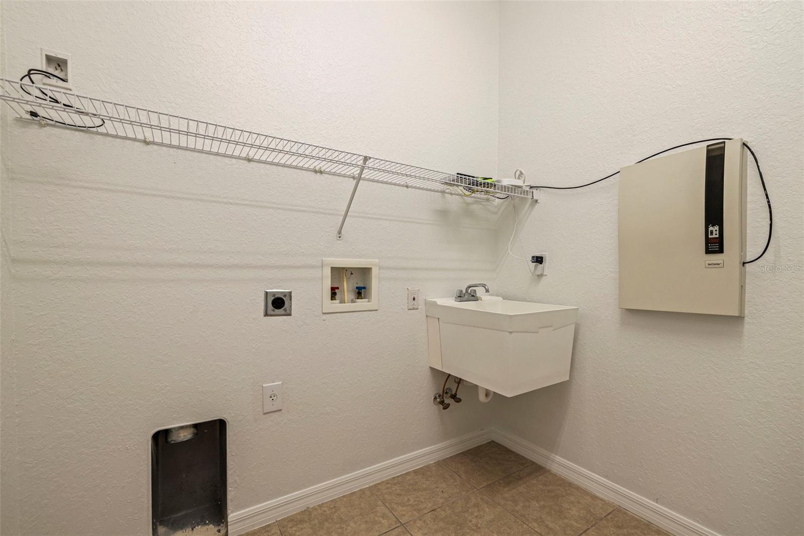 Laundry Room has Pocket Door, Laundry Tub & Shelving