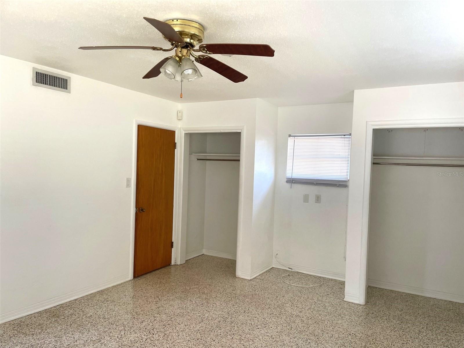 Primary bedroom w/2 closets. Door leads to hallway, 2nd bath & 2nd bedroom.