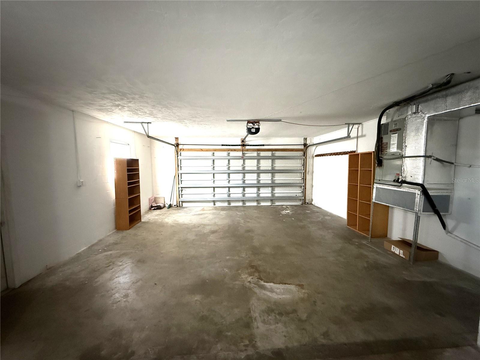 Oversized 2-car garage with door opener.