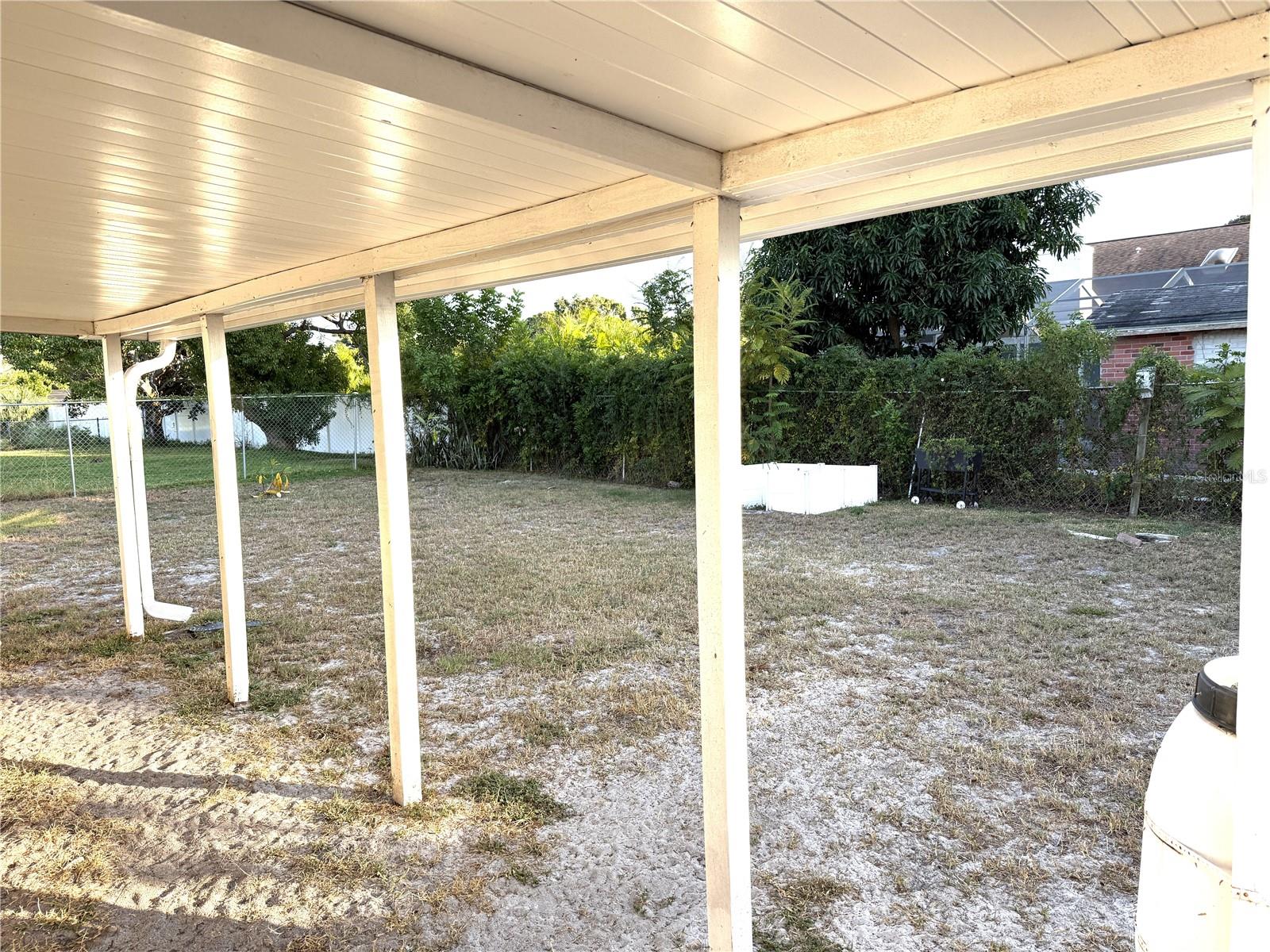 Outside covered area adjacent to screened Lanai.