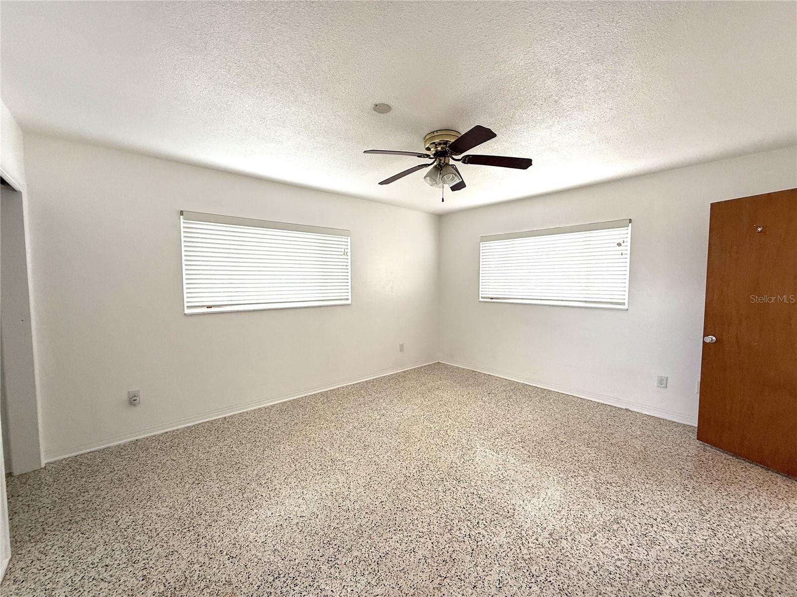 Looking into Primary bedroom from the bedroom door. Door on right is to the ensuite bath.
