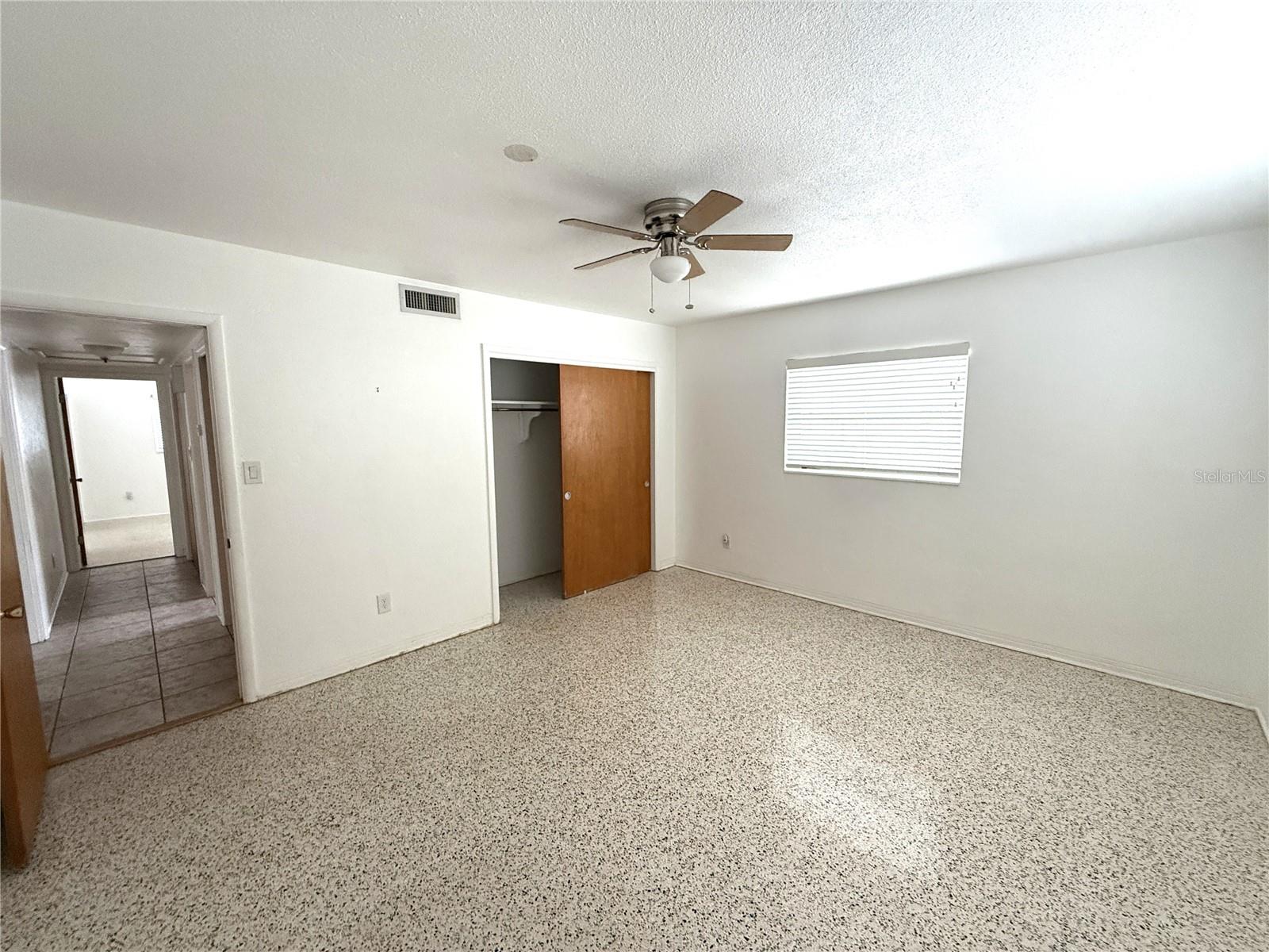 Bedroom 2. Hallway leads to hall bath and primary bedroom beyond.