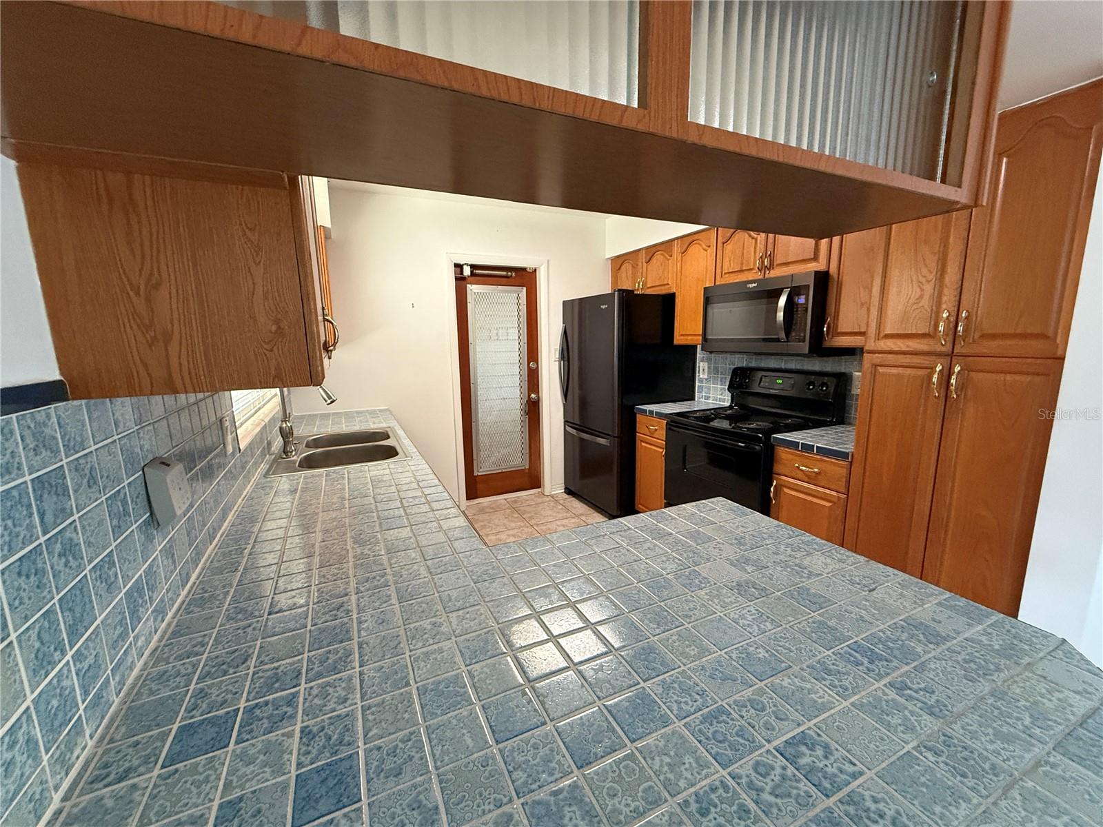 Kitchen  looking into kitchen from breakfast bar, toward door to garage.