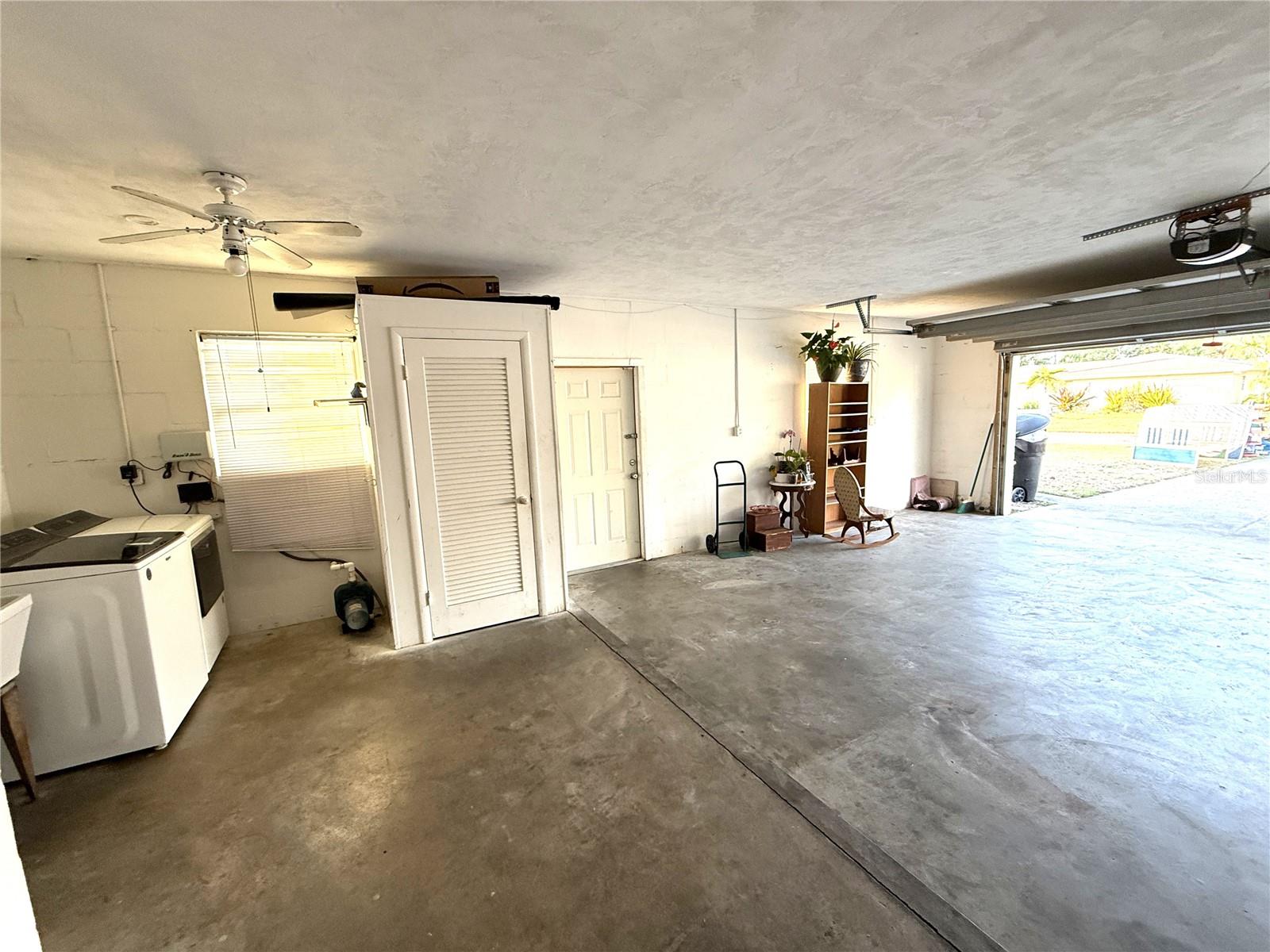 Oversized 2 car garage with washer/dryer hook ups, laundry sink ceiling fan/light and storage closet