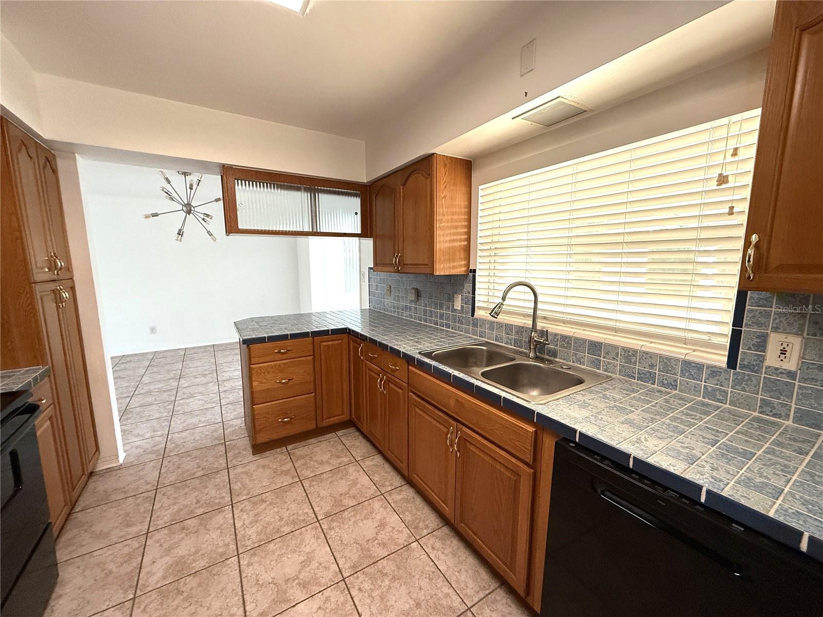 Kitchen looking toward breakfast bar and dining area beyond.
