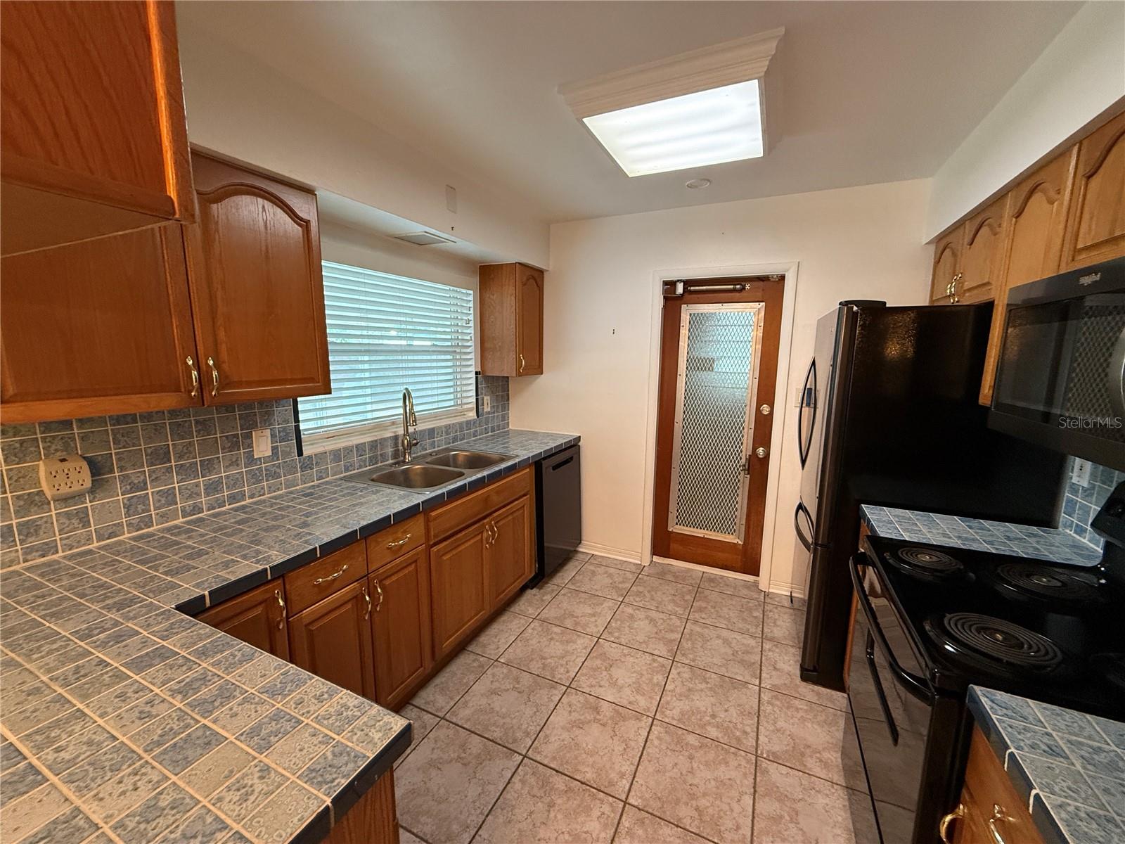 Looking into kitchen from breakfast bar area