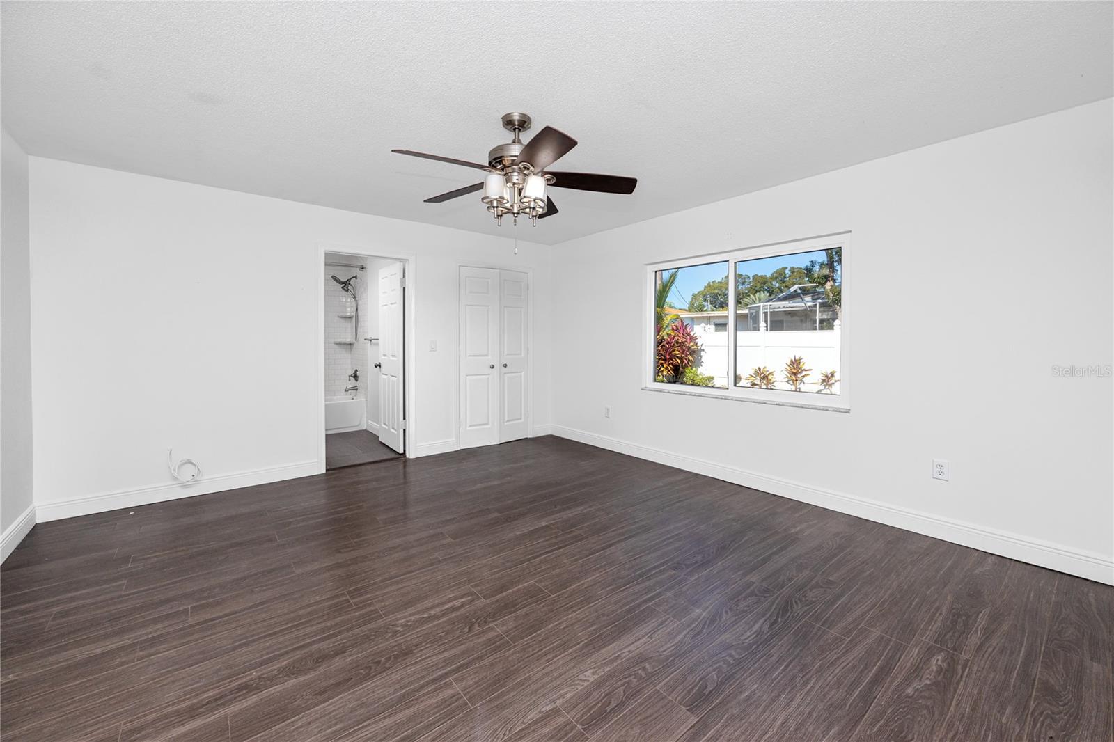 Primary bedroom with ensuite bath and walk-in closet