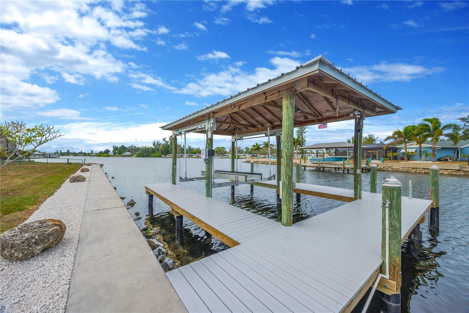 The recently constructed covered boathouse and dock, complete with a powered boat lift, water, and electricity, can accommodate a boat up to 26'. With deep-water Ruskin Inlet frontage and direct, bridge-free access to Tampa Bay