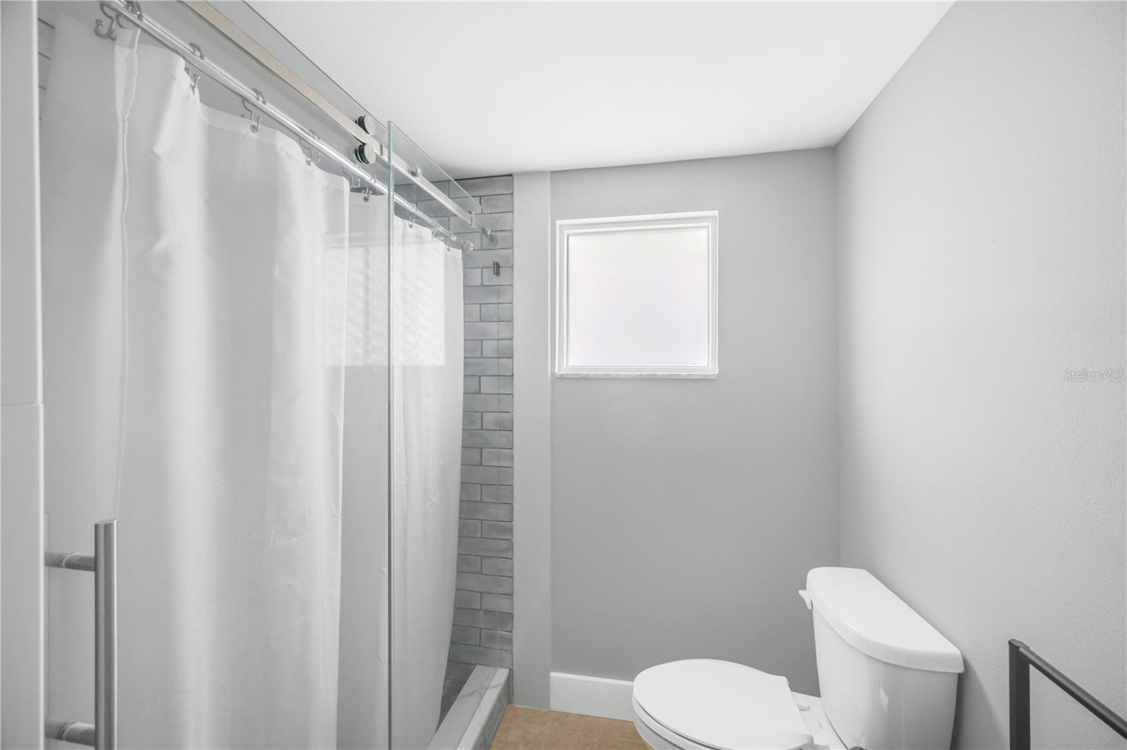 Bathroom #1 has a large step in shower with floor to ceiling tile.