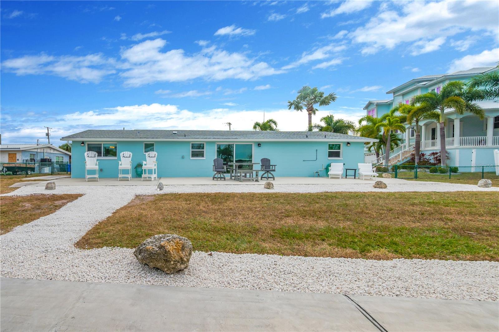 A massive back patio overlooks the inlet—perfect for morning coffee, unwinding in the evenings, or entertaining year-round.