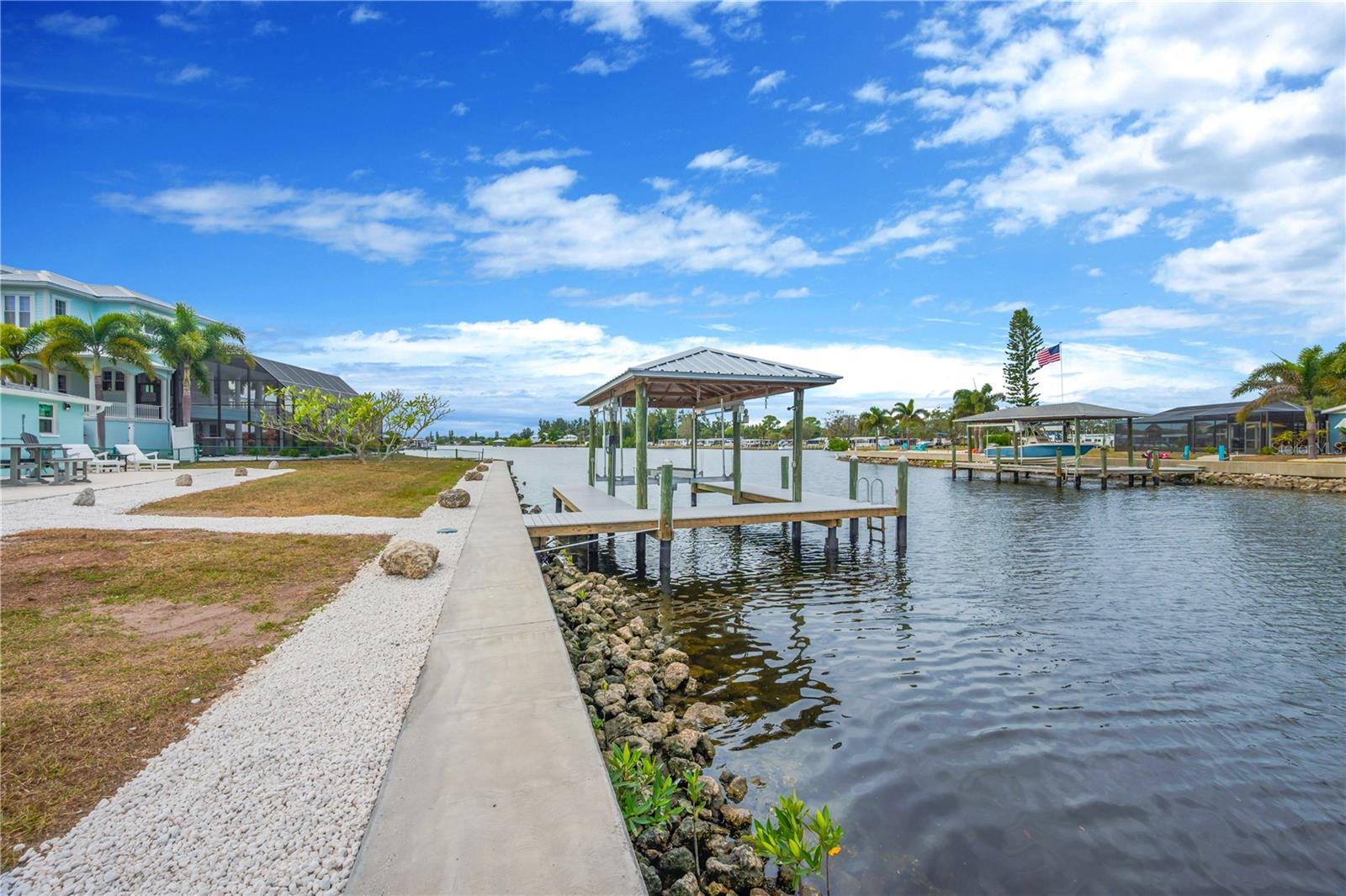 The seawall has also been recently reinforced with riprap stone, providing added durability and long-term protection against erosion.