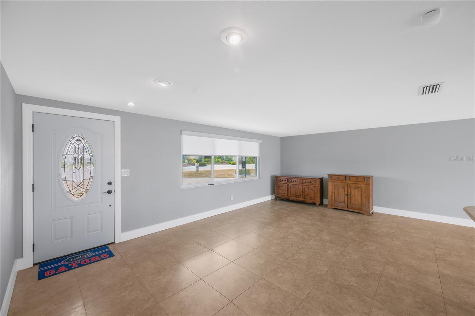 Notice the eye-catching front door accented with a beautiful leaded-glass insert.