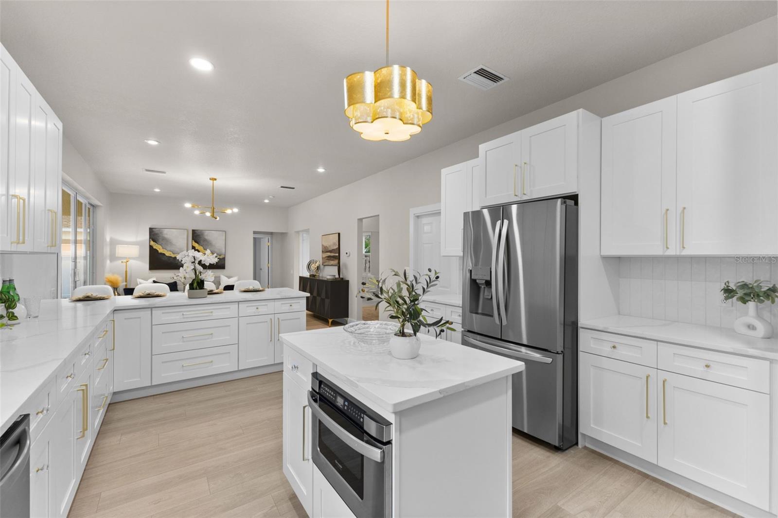 With generous storage, brand-new stainless steel appliances, and elegant quartz countertops, this kitchen offers a truly timeless feel.