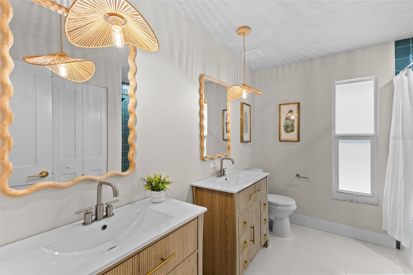 Two separate vanities, a shared bath, and a large linen closet for added convenience.