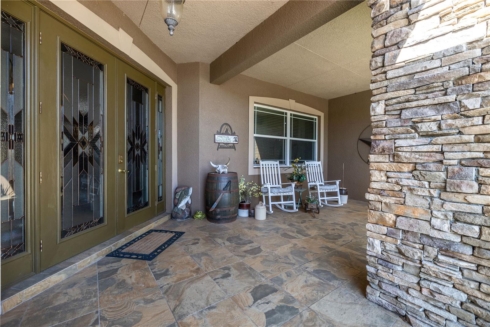 Custom stone work and double glass front door.