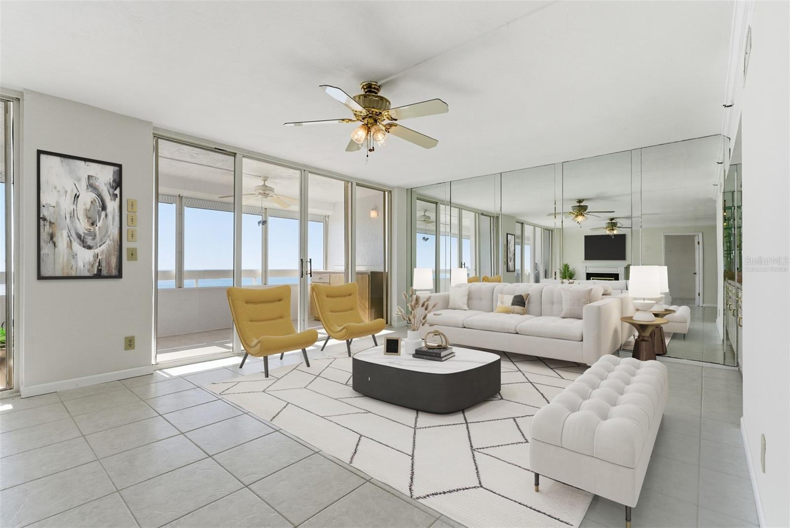 Bright, open living area ideal for hosting family and friends, with plenty of seating and the Gulf just beyond the sliders. (Virtually staged)