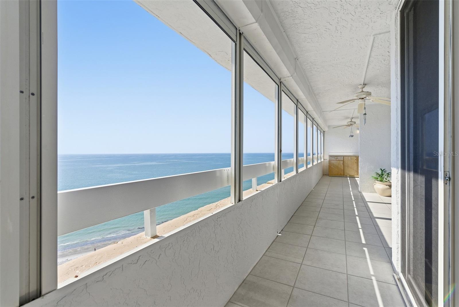 Step out to an extended balcony where the coastline, horizon, and shimmering water are always in view.