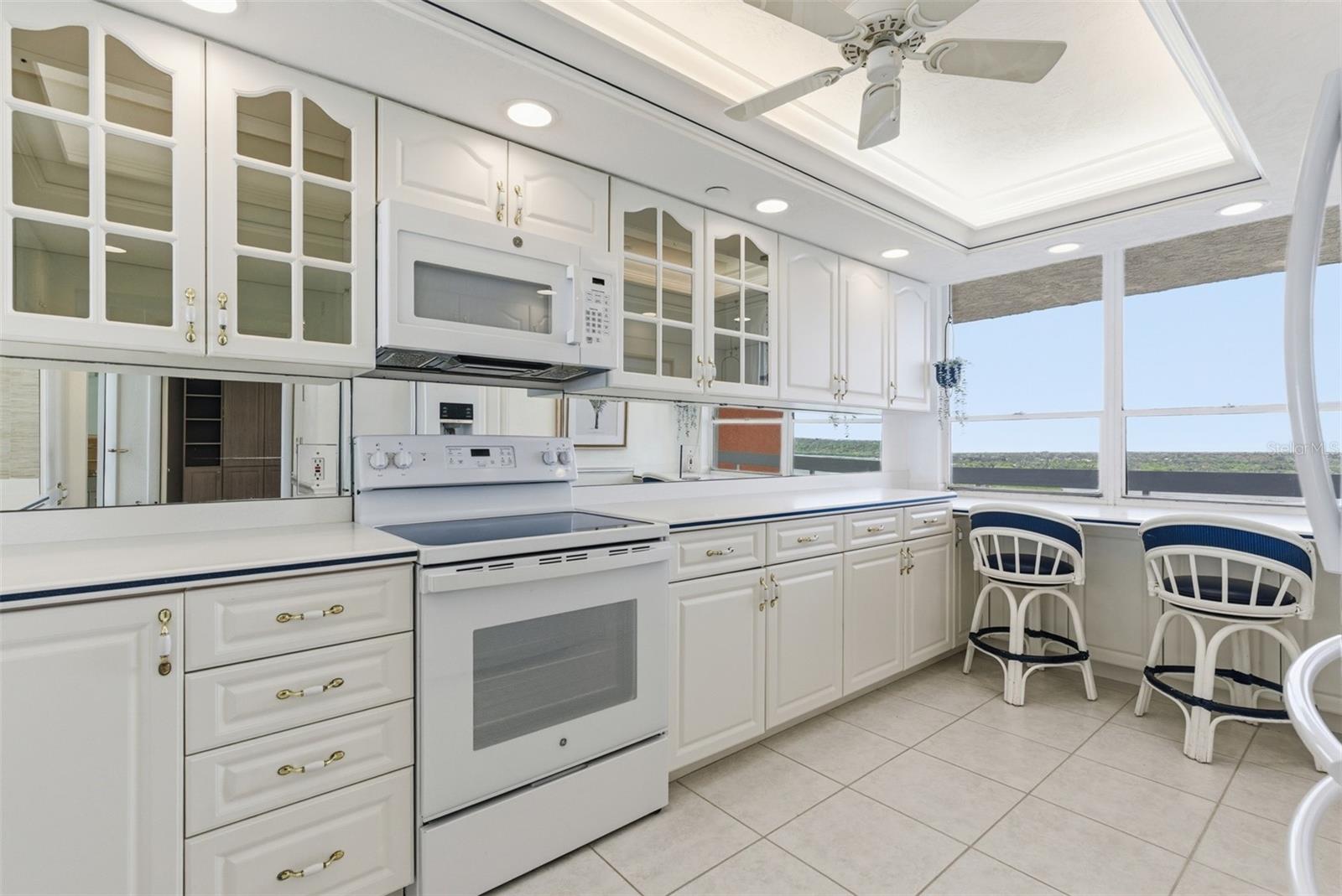 Bright, fully equipped kitchen with extensive cabinet and counter space.