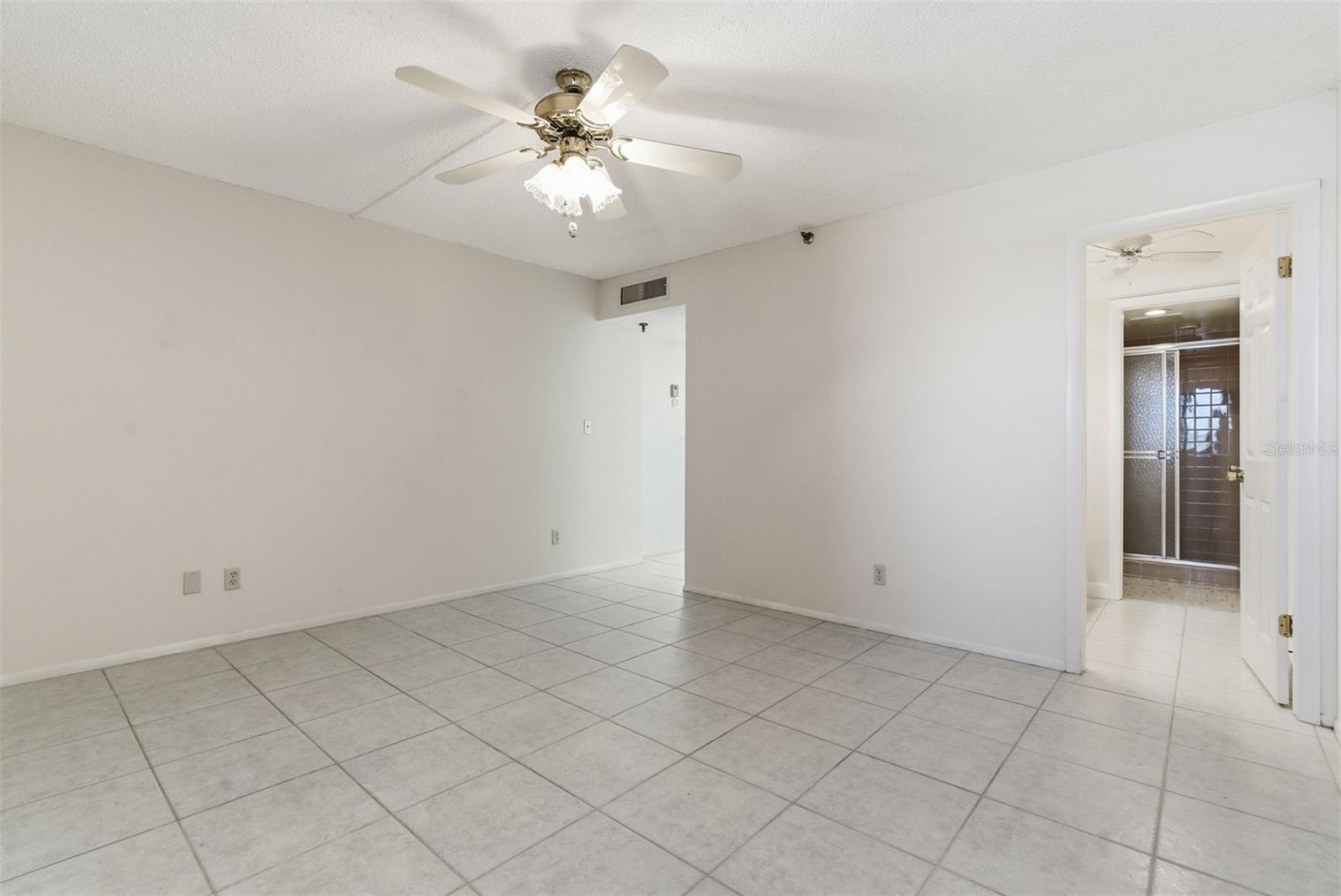 Spacious second bedroom with a private full bath and generous walk-in closet.