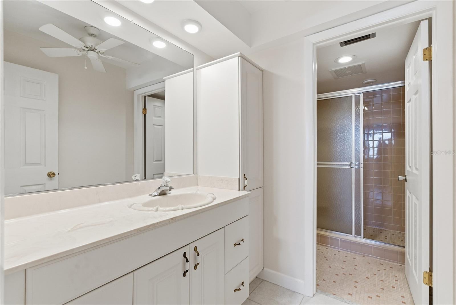 En-suite full bath conveniently connected to the second bedroom.