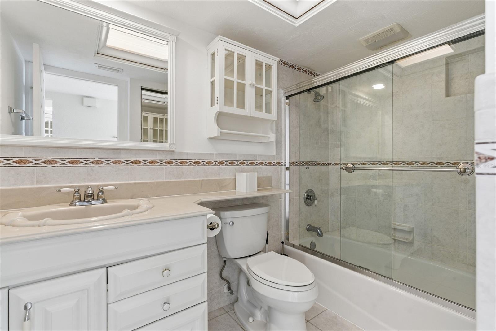Guest bathroom conveniently located off the living area, featuring a tub/shower combo.