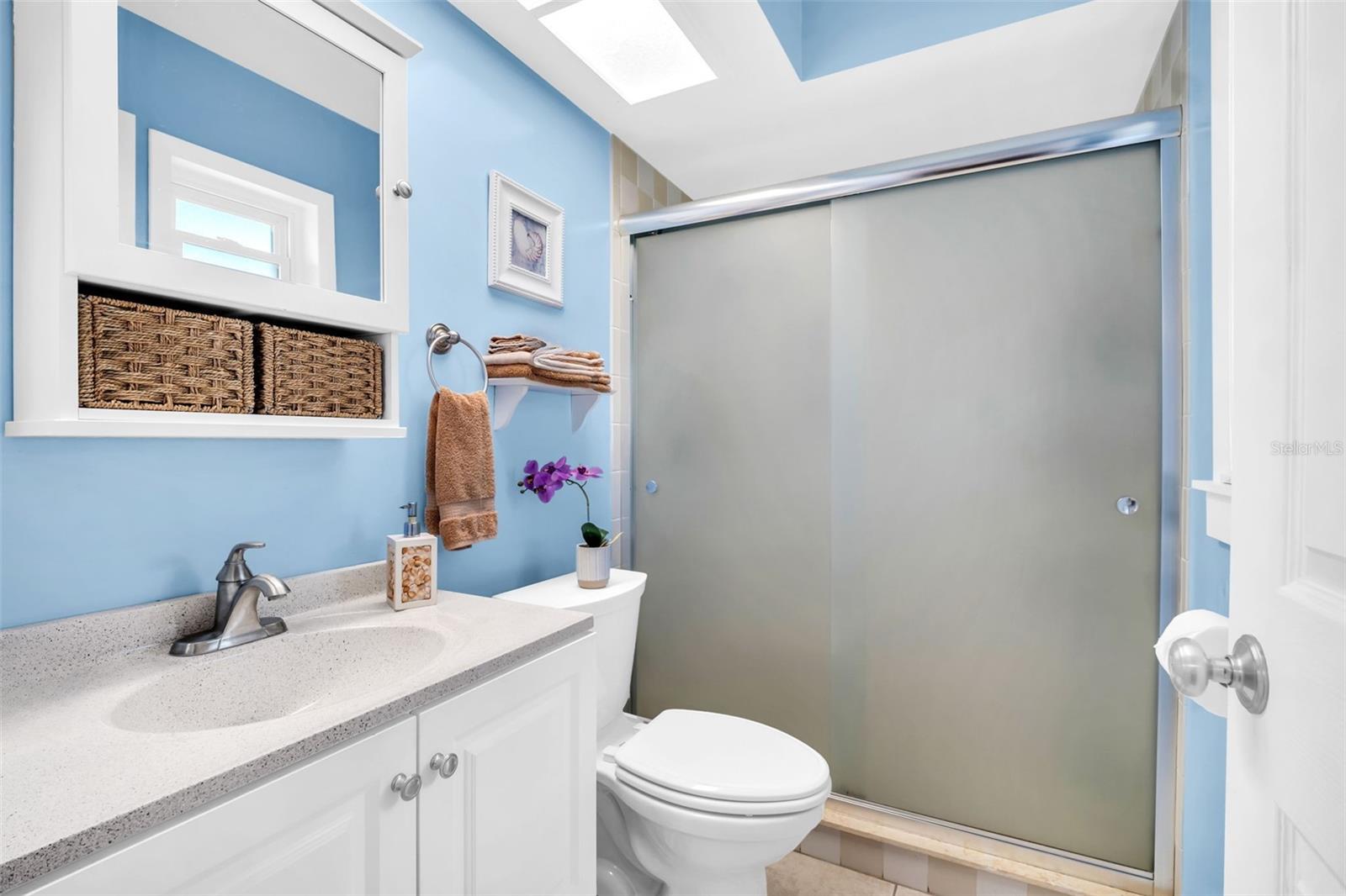 Master en-suite with a glass walk-in shower & updated vanity~