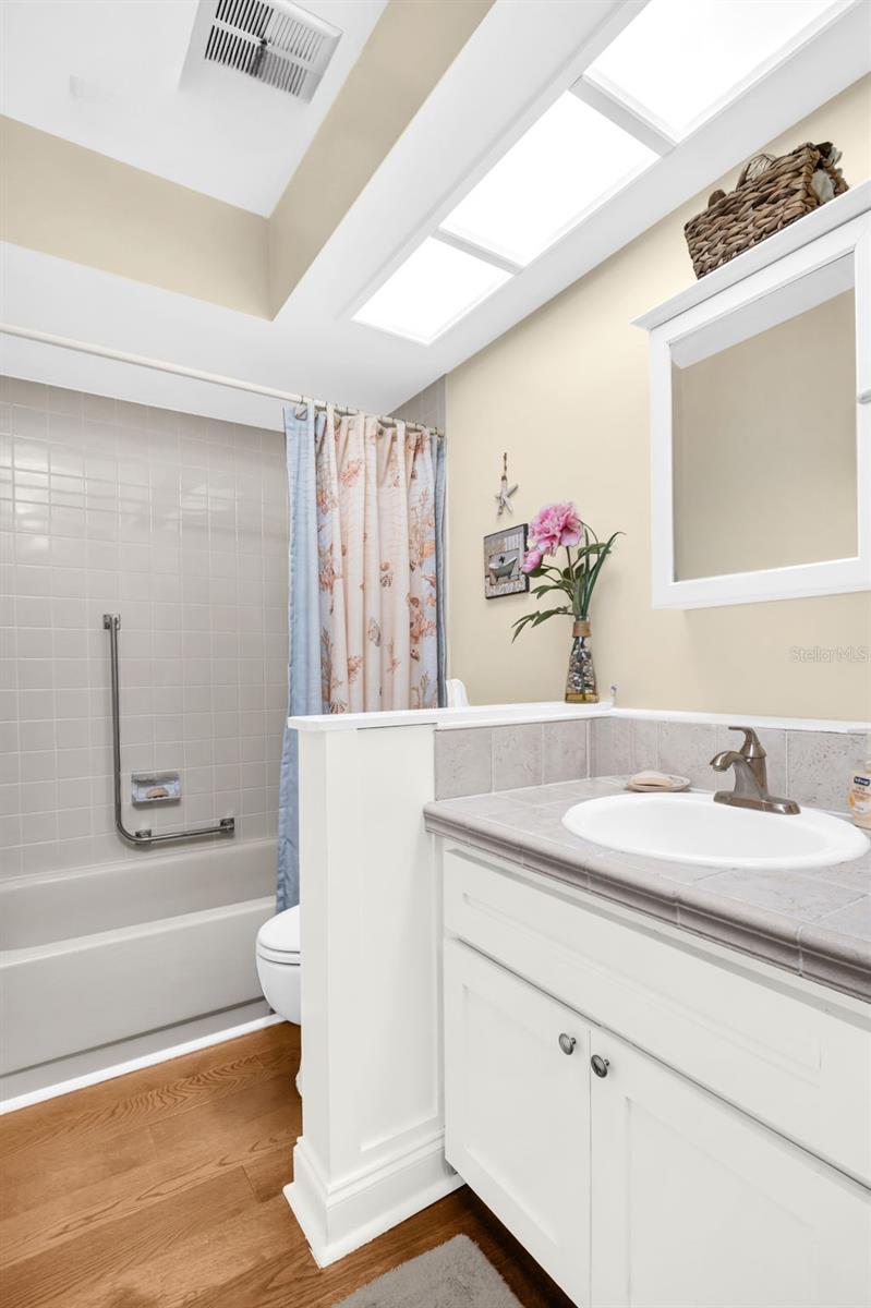 Hall bath with tub/shower combo & updated vanity~