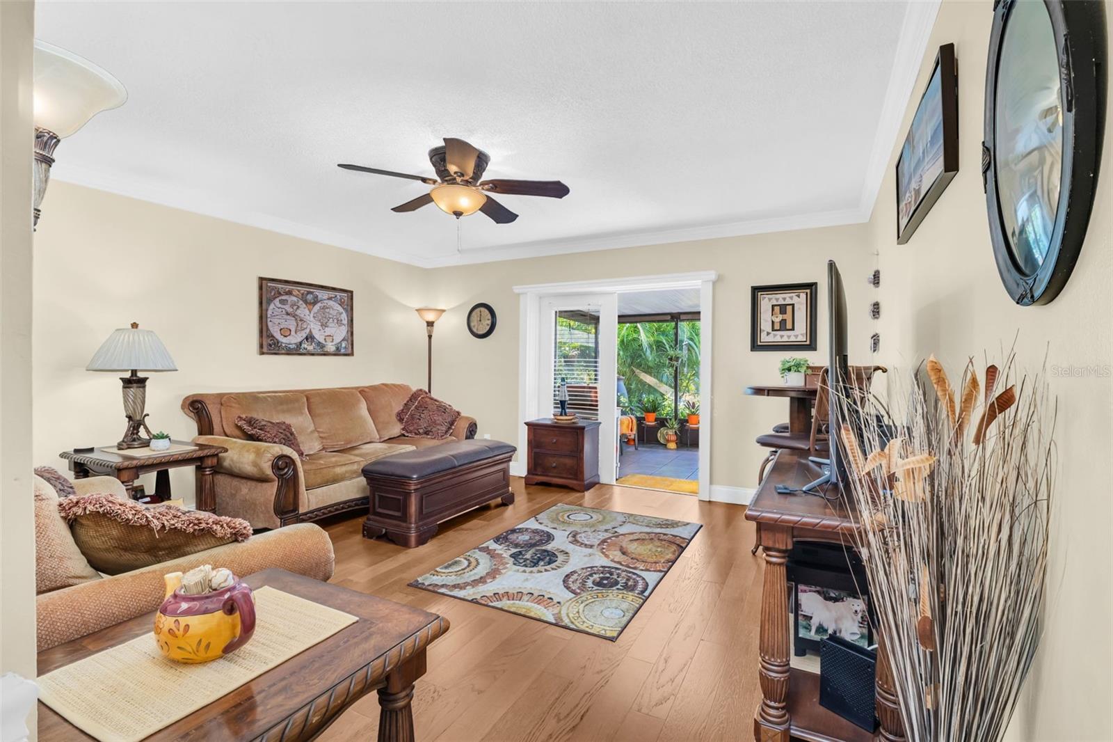 Spacious main living room with updated glass French doors out to second screened in lanai~