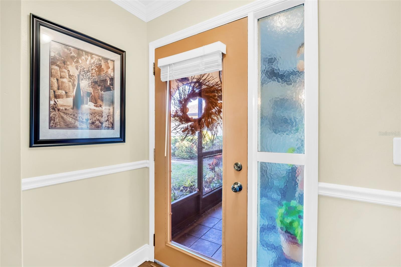 Immediately greeted with natural lighting flowing throughout, chair rail & crown molding~