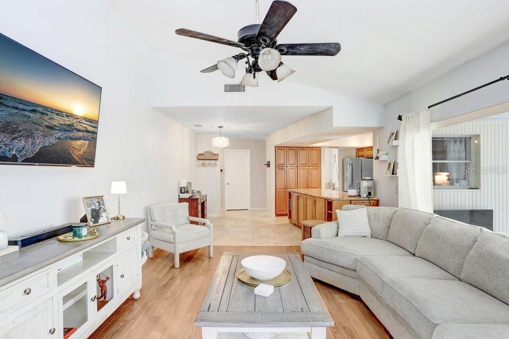Family room with wood burning fireplace open to dinette and kitchen