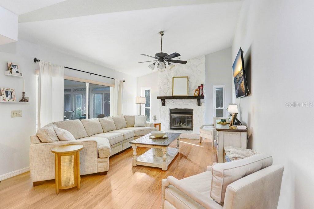 Family room with wood burning fireplace and sliders that open to the lanai
