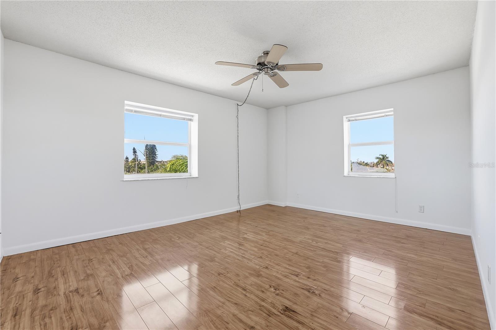 Primary Bedroom has lots of light. Corner unit.