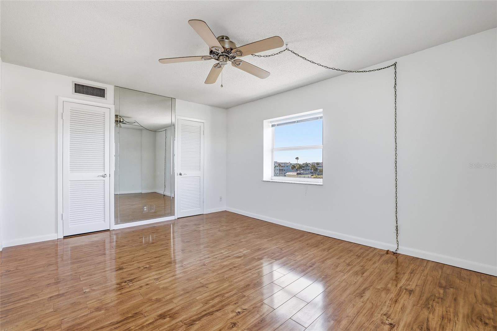 Primary bedroom has large closet with two doors.