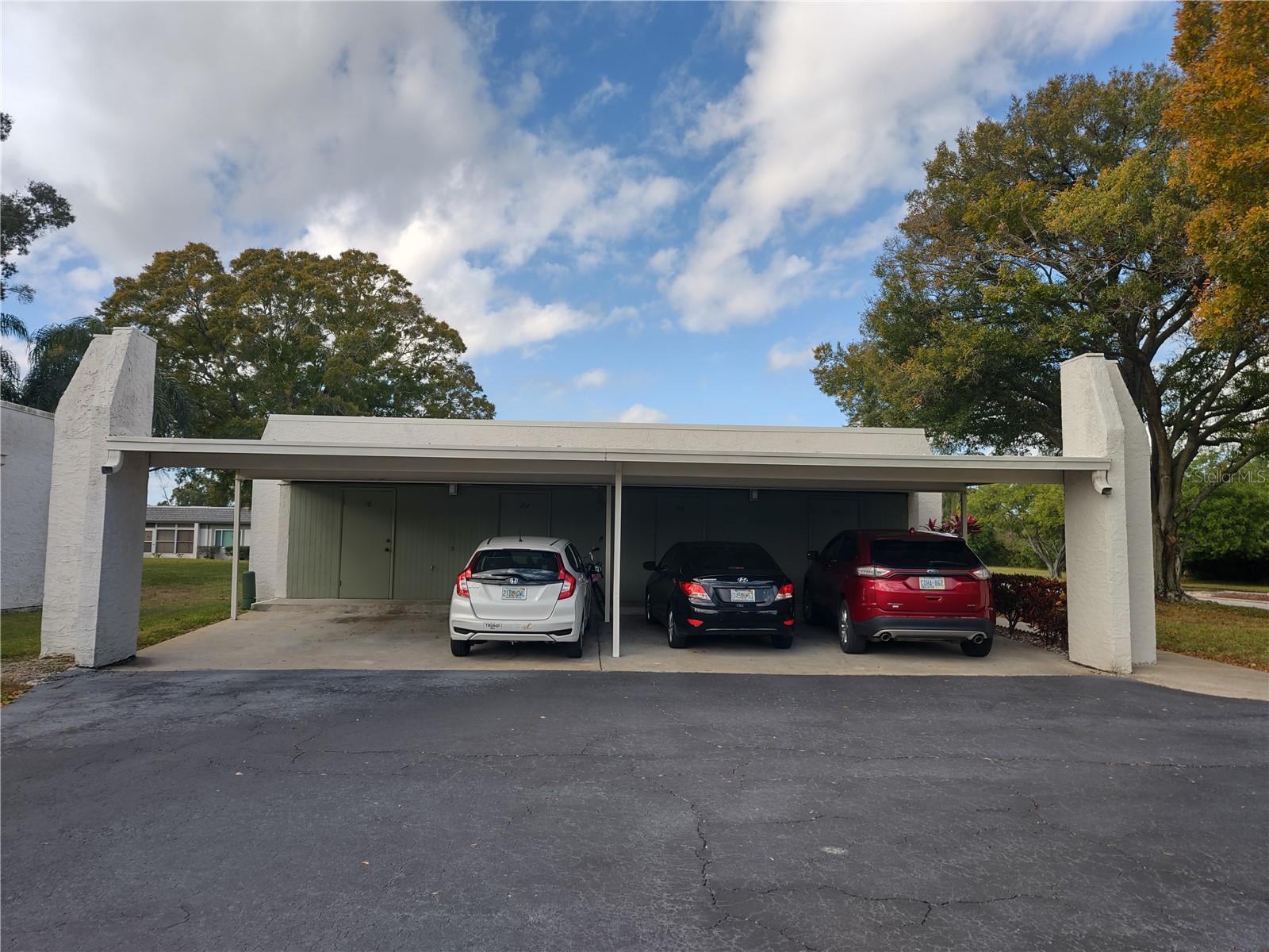 Assigned covered carport space (2C to far right) includes storage area.