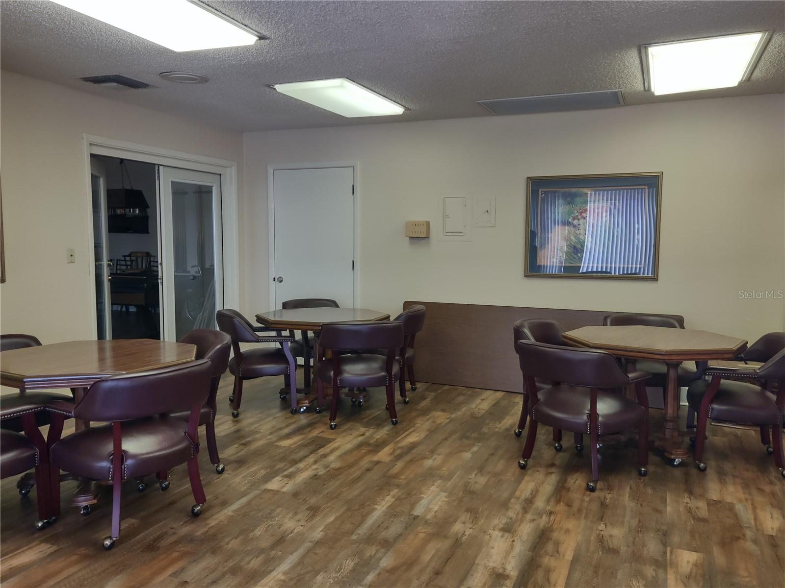 Leisure room, adjacent to game room, offers sitting area for board game/card playing  events or just socializing.