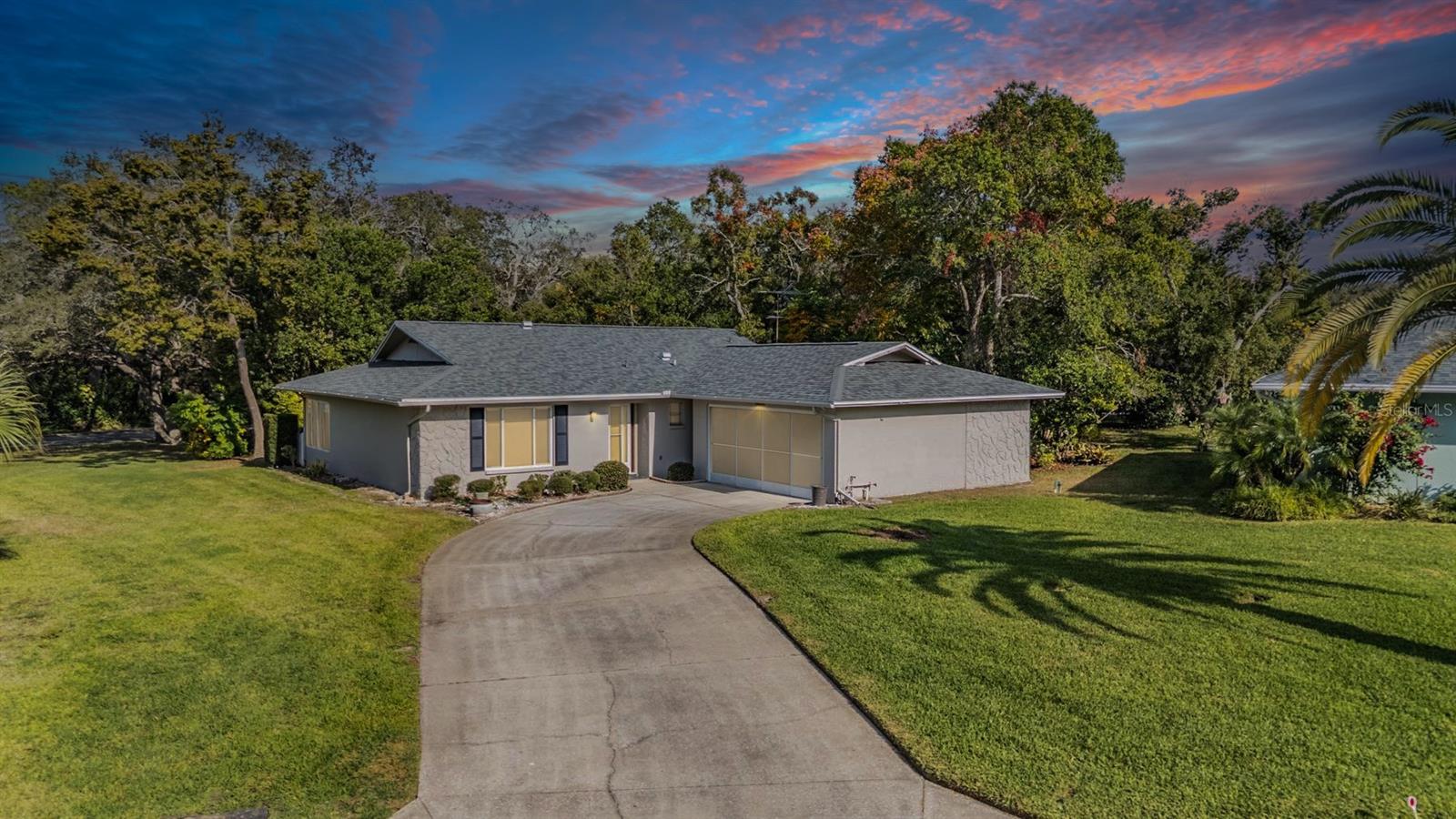A pie-shaped lot with a lush backdrop