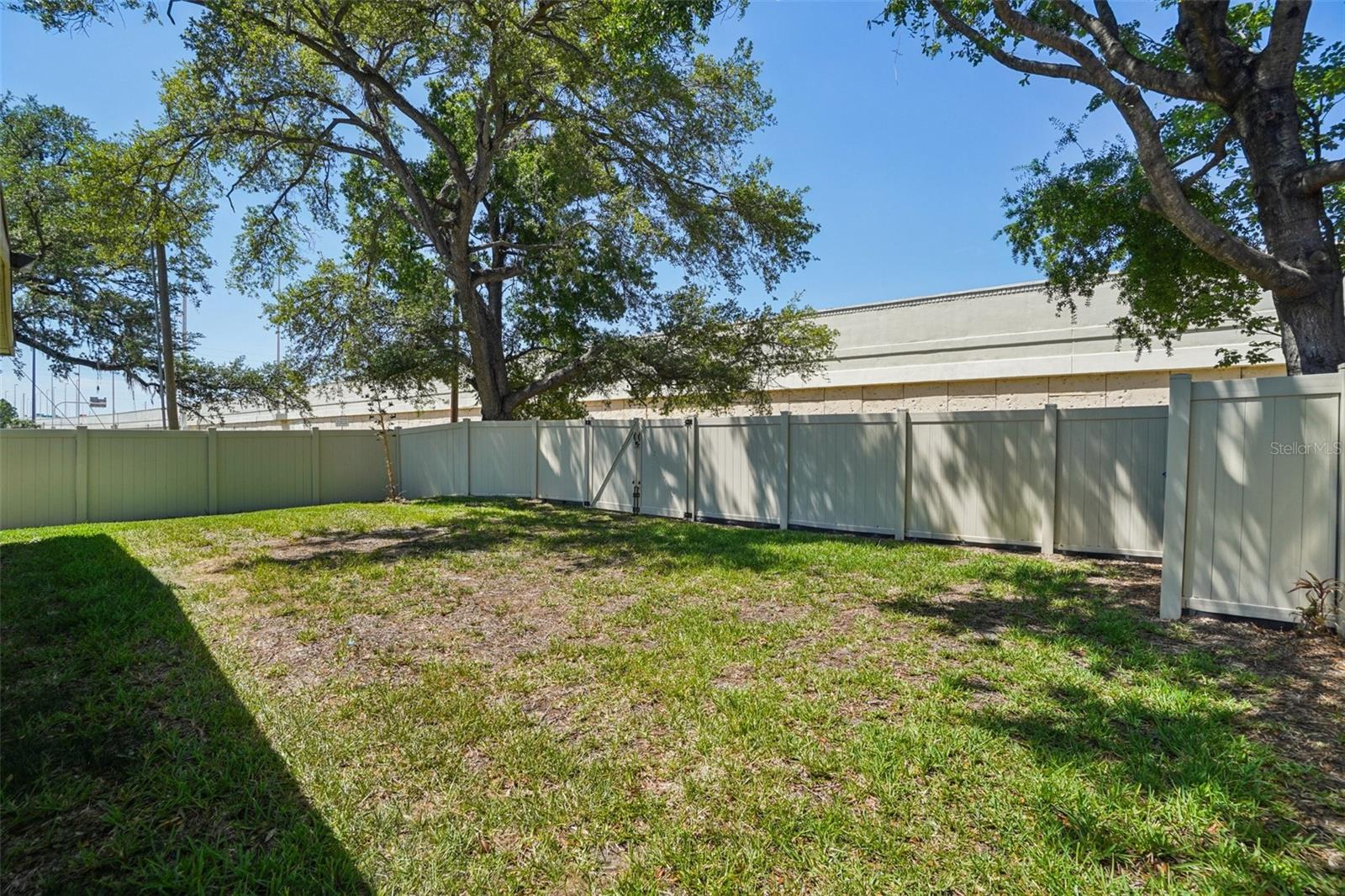 Large back yard comletely fenced with two entry gates in back which open to a former alleyway.