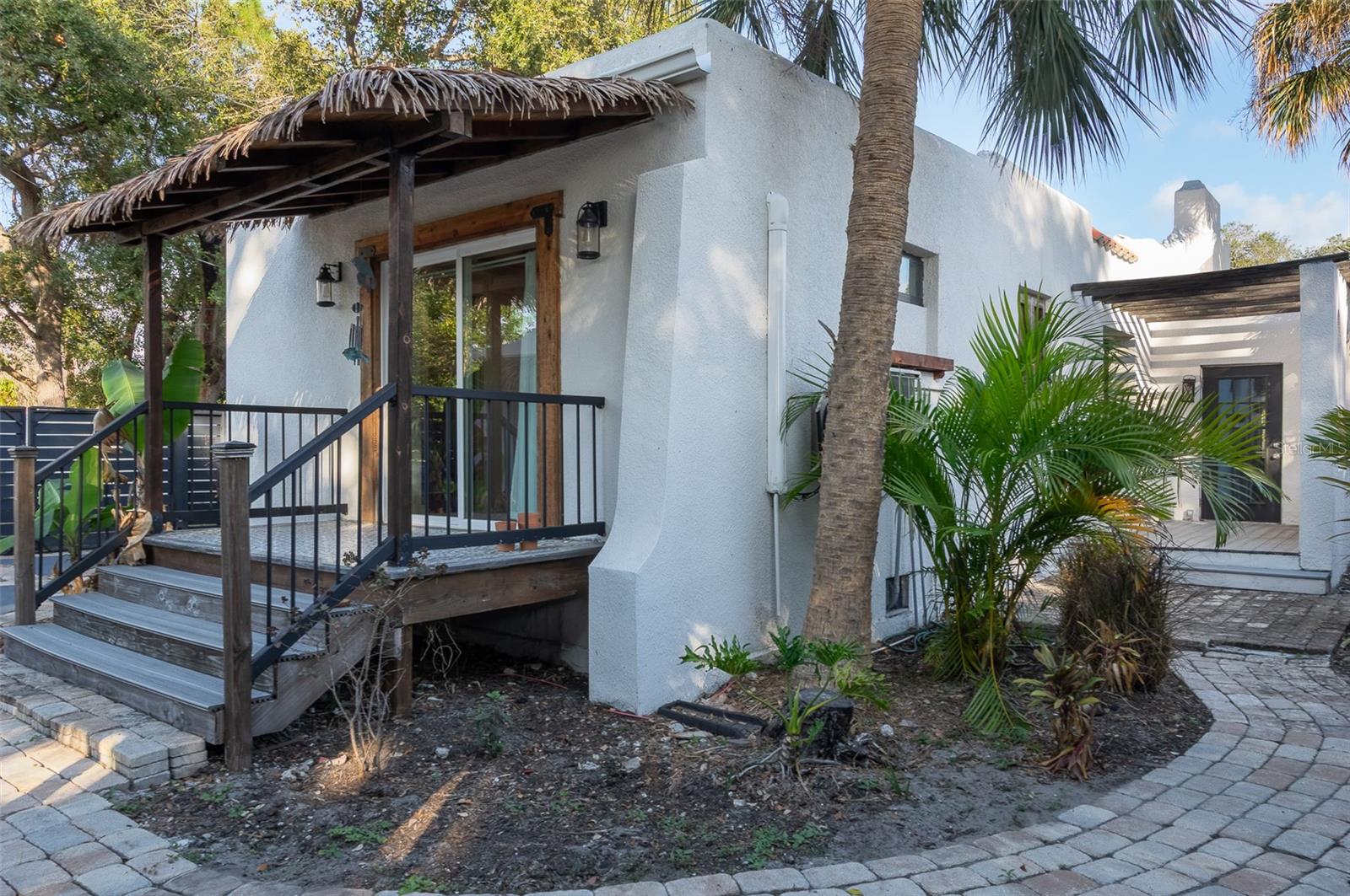 Private porch off primary bedroom and side patio to the right
