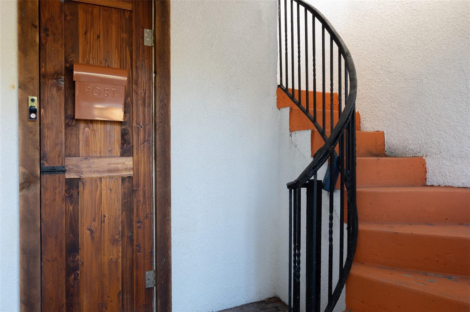 Storage, mailbox, and stairway to private rooftop terrace
