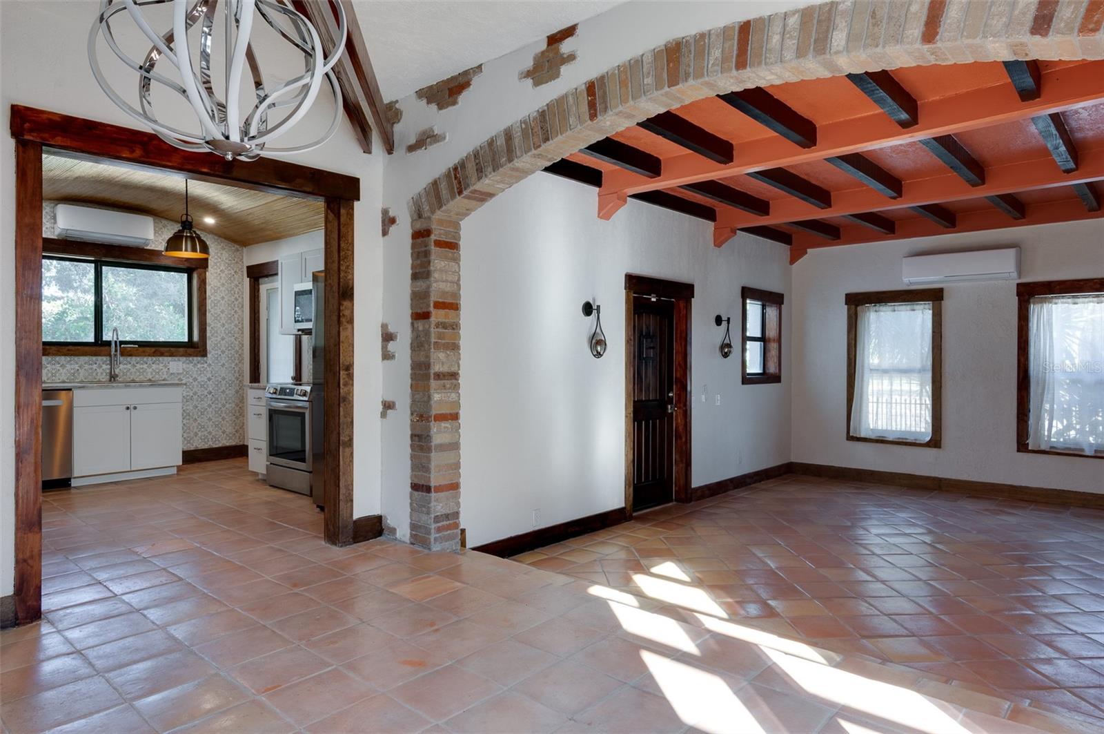 Dining space looking into living room front door area as well as kitchen