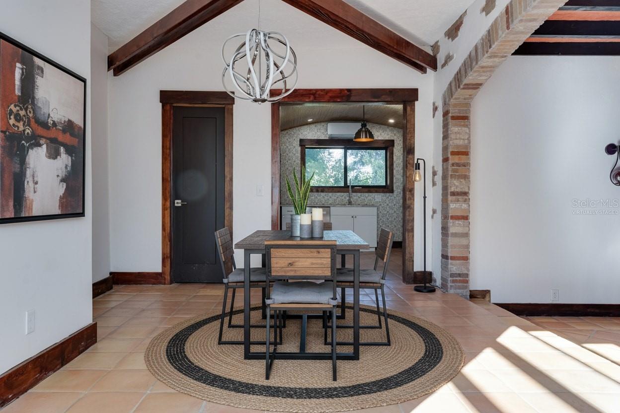 Virtually Staged Dining Room looking toward kitchen with second bath doorway