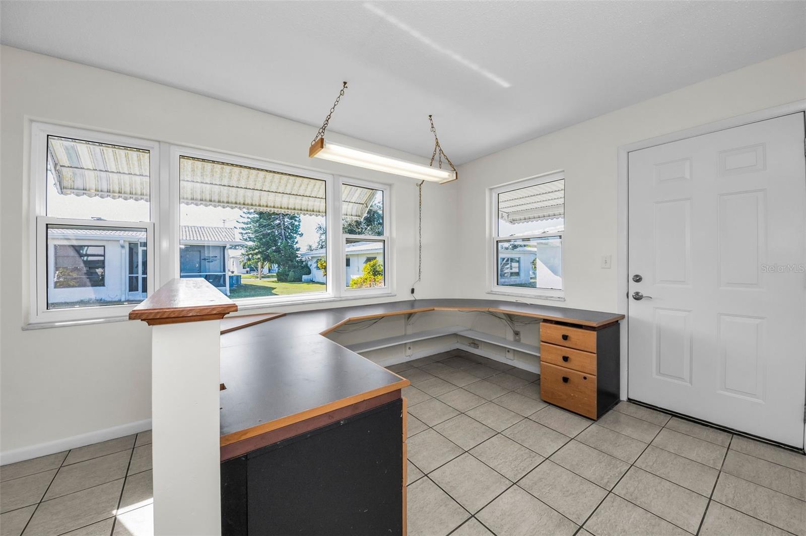 Office with a built-in desk in the Sunroom