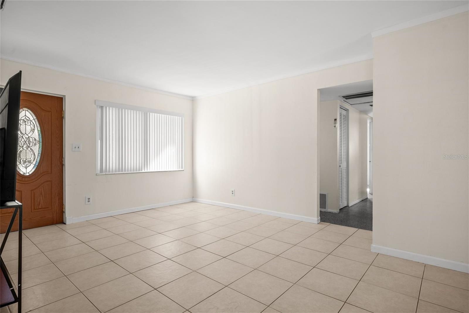 Living Area with hallway to shared bathroom and 3 bedrooms